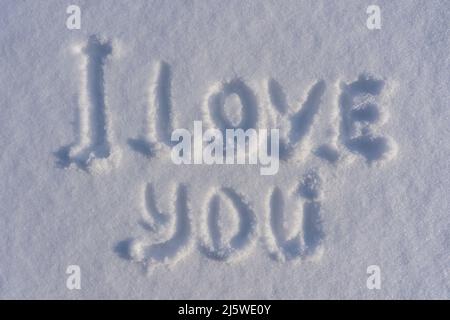 Text I love you on a white fresh snow in winter, close up. Drawings of the words I love you in the winter season Stock Photo