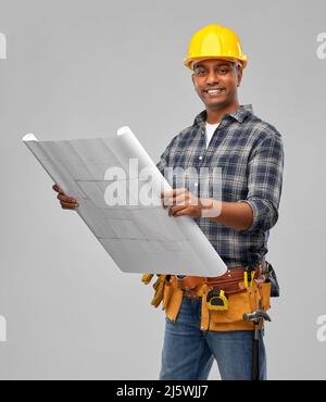 happy indian builder in helmet with blueprint Stock Photo