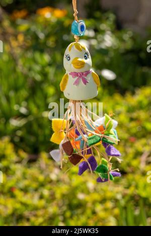 Mugla, Turkey 04.25.2022: Cute chick  decoration hanging on green meadow background. Happy Easter Celebration Ornament concept.  Colorful card Stock Photo