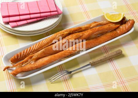 Fresh smoked salmon bellies on a plate close up for lunch Stock Photo
