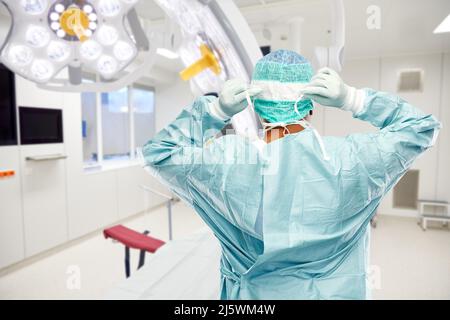 male surgeon doctor in protective wear at surgery Stock Photo
