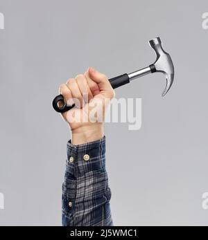 close up of builder's hand holding hammer Stock Photo