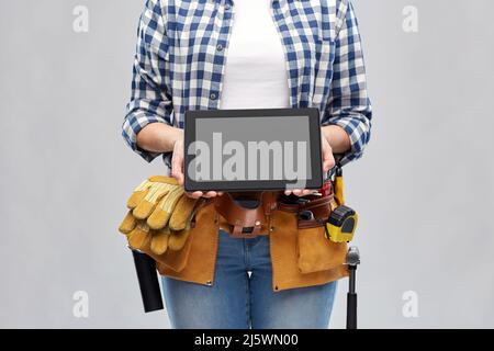 woman builder with working tools showing tablet pc Stock Photo