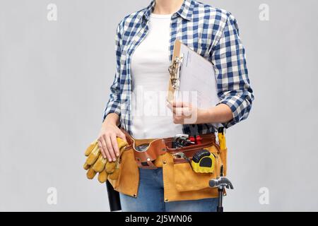 woman with clipboard, pencil and working tools Stock Photo