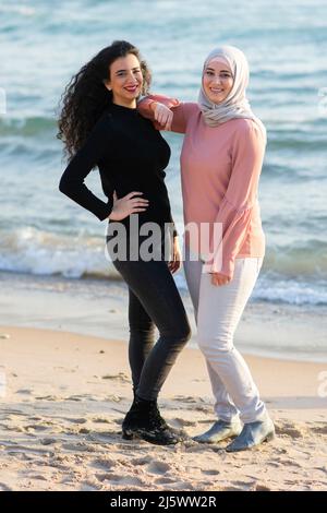 Muslim sisters on the beach Stock Photo