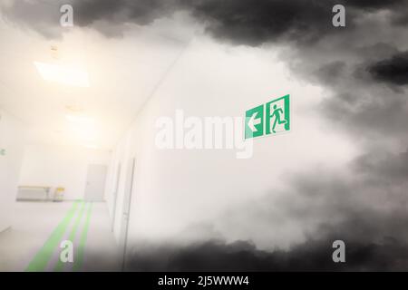 Emergency exit and smoke in office building Stock Photo