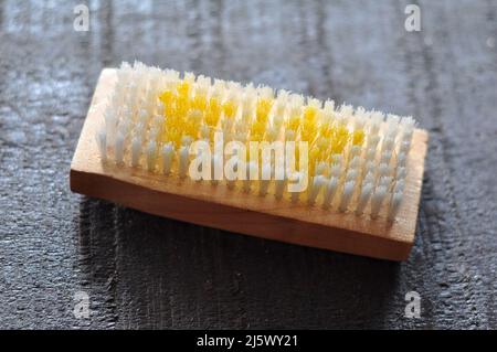Synthetic brush with wooden handle on the floor Stock Photo