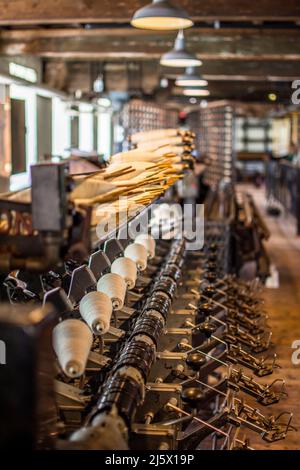 Machines in an old cotton mill. Stock Photo