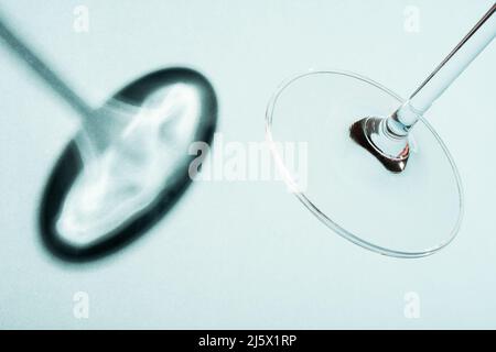 Wine glass stem and base with shadow on blue background. Stock Photo