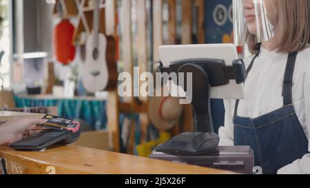 Customer woman using digital wireless or contactless payment using credit card without money for buying coffee in cafe coffee shop, small business acc Stock Photo