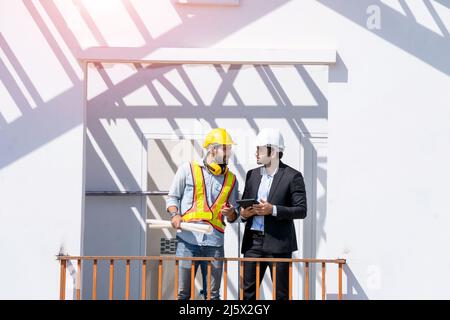 Engineer and businessman planning new residential subdivision home building in construction site. Stock Photo