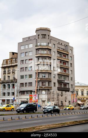 Main road and  stark architecture apartment block in downtown Bucharest, capital city of Romania, central Europe Stock Photo