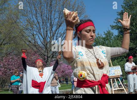 Dancers from the Calpulli Mexican Dance Group march, dance, celebrate & give gratitude at the anniversary of Escuelita en Casa. In Queens, NYC. Stock Photo