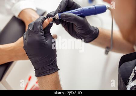 Professional manicure master working on nails in salon Stock Photo