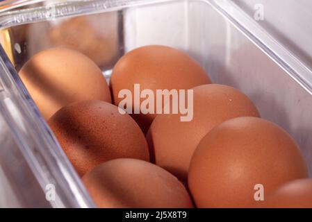 Eggs in the refrigerator arranged in rows. Low temperature storage of eggs. The structure of the shell in close-up. Stock Photo
