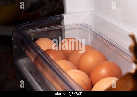 Eggs in the refrigerator arranged in rows. Low temperature storage of eggs. The structure of the shell in close-up. Stock Photo