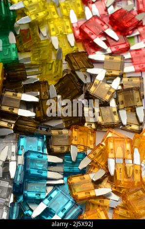 FIRECRACKERS: Color assorted spark plugs for an automobile fuel pump rest in a pile. Stock Photo