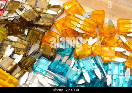 FIRECRACKERS: Color assorted spark plugs for an automobile fuel pump rest in a pile. Stock Photo