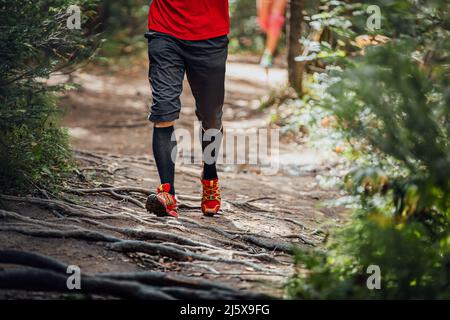 male runner in compression calf sleeve run over rocks Stock Photo - Alamy