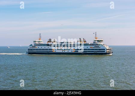 A passing ferry at mid-sea on its way from Dutch island Texel to the city of Den Helder. The boat service is operated by private ferry company TESO. Stock Photo