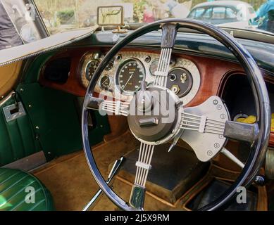 Image showing the very large steering wheel and dashboard of a pre war car Stock Photo