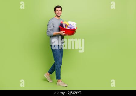 Full size profile side photo of cheerful handsome male prepare to do household chores isolated on green color background Stock Photo