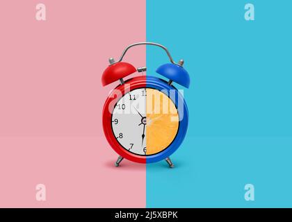 Awakening vintage metal clock on two-tone background Stock Photo