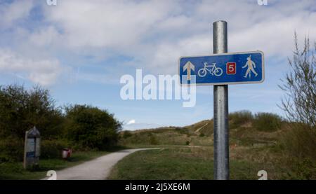 selective focus of cycle path footpath directional sign in blue at Talacre dunes north wales Stock Photo