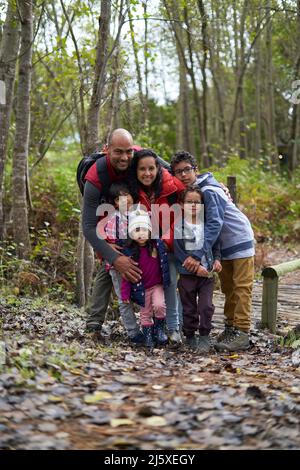 Portrait happy affectionate family hiking in woods Stock Photo
