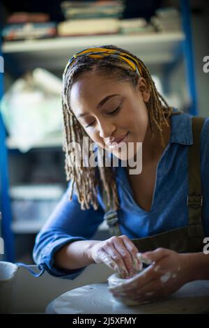 Young woman at pottery wheel Stock Photo