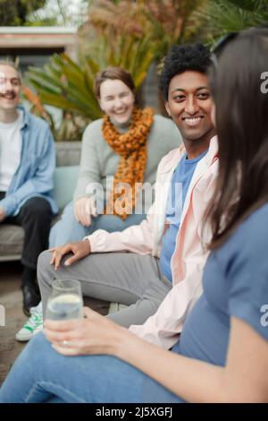 Happy couple friends talking on patio Stock Photo