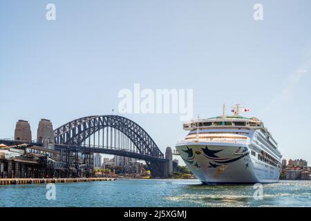 Sydney, Australia - April 19, 2022: Pacific Explorer cruise ship getting tugged from Sydney Harbour to White Bay Cruise Terminal after its triumphant Stock Photo