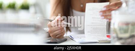 Focus on tender hands of businesswoman sitting indoors with metallic silver pen Stock Photo