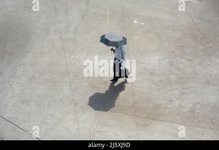 Kolkata, West Bengal, India. 26th Apr, 2022. A man came outside holding an umbrella in a hot summer day.Today's temperature in Kolkata is around 40Â°c. The Met office declaredÂ a heatwave alertÂ for most districts in South Bengal till 28th April.But it will continue to be warm and uncomfortable with no chance of rain, according to the Regional Meteorological Centre (RMC) till April 28. (Credit Image: © Rahul Sadhukhan/Pacific Press via ZUMA Press Wire) Stock Photo