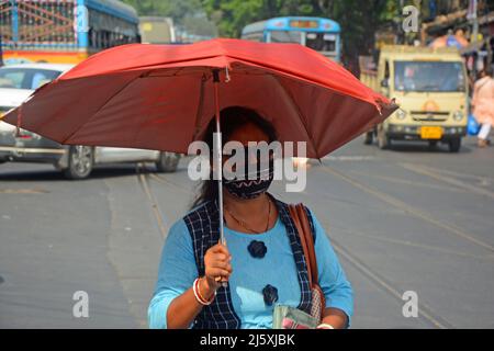 Kolkata, West Bengal, India. 26th Apr, 2022. A woman came outside holding an umbrella in a hot summer day.Today's temperature in Kolkata is around 40Â°c. The Met office declaredÂ a heatwave alertÂ for most districts in South Bengal till 28th April.But it will continue to be warm and uncomfortable with no chance of rain, according to the Regional Meteorological Centre (RMC) till April 28. (Credit Image: © Rahul Sadhukhan/Pacific Press via ZUMA Press Wire) Stock Photo