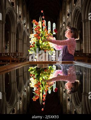 Caroline Baldwin puts the finishing touches to a floral display at Ripon Cathedral in North Yorkshire, that forms part of a celebration of the life and legacy of Ripon Cathedral's founding father, Wilfrid. Picture date: Tuesday April 26, 2022. Stock Photo