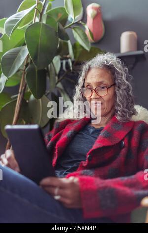 Senior woman using digital tablet Stock Photo