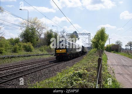 Staffordshire, UK 26th April 2022.  Steam train 60007 ”Sir Nigel Gresley” passes through Penkridge behind a diesel locomotive en route to Crewe after being the star attraction at the Severn Valley Railway Spring Gala over the weekend .  Credit Richard O'Donoghue/Alamy Live News Stock Photo