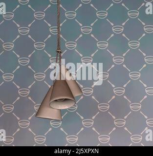 Digitally enhanced photo of three retro style hanging lamps against a blue pattern wallpaper design Stock Photo
