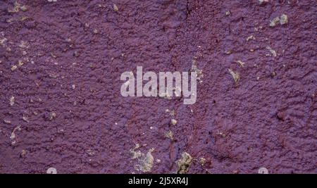 Old purple colored concrete wall with lots of texture Stock Photo