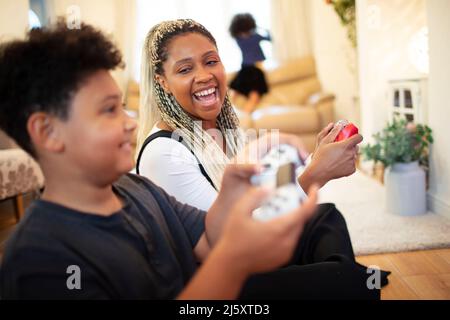 Happy mother and son playing video game Stock Photo