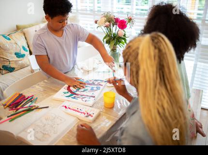Family painting at table Stock Photo