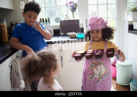 Kids baking cupcakes in kitchen Stock Photo