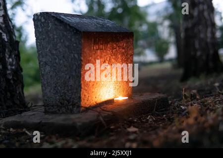 A candle near the monument to fallen soldier during the Great Patriotic War. World War II. The Day of Remembrance and Mourning in Russia is June 22. Stock Photo