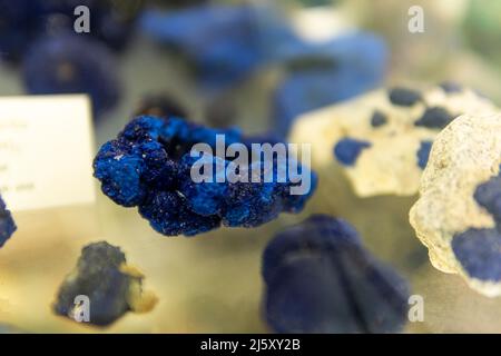 Lapis lazuli blue gemstone on a glass shelf Stock Photo