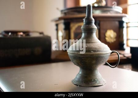 Old oil lamp on a table. Stock Photo