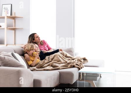 Pile of sweet crunchy cookies with chocolate chips placed on table with crumbs and milk on white background in room Stock Photo