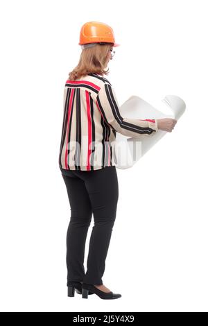 rear view. adult female architect reading a new drawing. isolated on a white background. Stock Photo