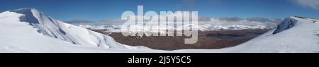 90MP size panoramic view over the Coire of Toll Mor on Fionn Bheinn, on a bright sunny winters day. Stock Photo