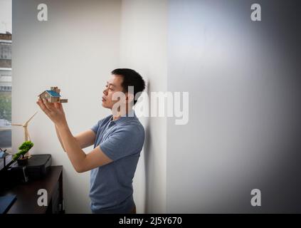 Male architect inspecting house model in office Stock Photo
